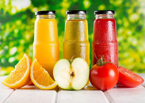 different bottles of juice with fruits
