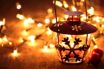 Lantern and Christmas lights burning in dark..
