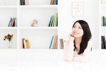 attractive asian woman thinking in the room