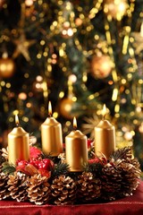 Advent wreath with Christmas tree in the background.