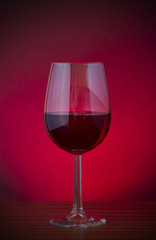Low key vignette image of red wine in a glass