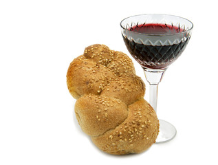 Challah  with glass of wine for Shabbat, isolated.