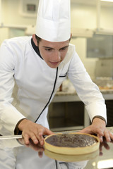 Pastry cook student making cake