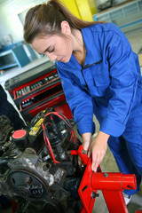 Student girl working in auto repairshop