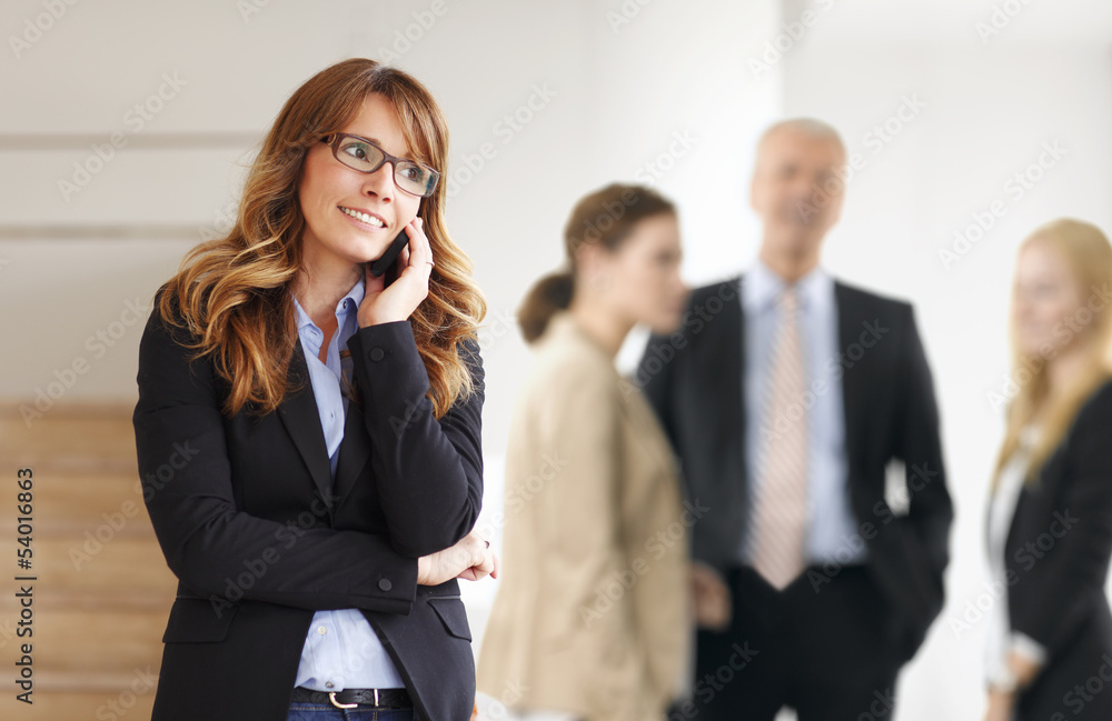 Wall mural smiling professional businesswoman on the phone