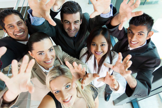 cheerful group of business people reach out