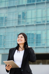 Entrepeneur with a tablet in front of a bulding