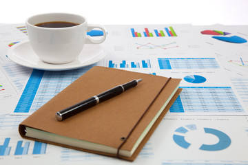 Business report with cup of coffee