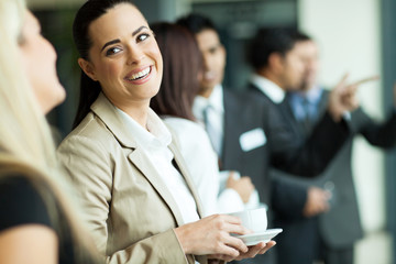 businesswoman having fun conversation with colleague during brea