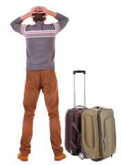 Back view of shocked business man with suitcase looking up.