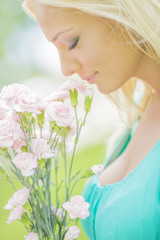 Young blond woman with flowers