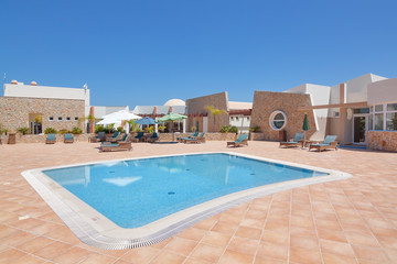 Fototapeta premium Luxury swimming pool in the hotel zone. Summer with umbrellas an