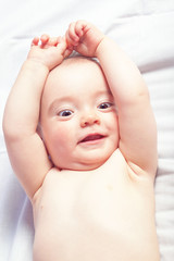 Happy baby girl playing and laughing. In the warm colors close-u