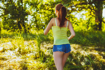Naklejka na ściany i meble brunette woman young runner running back view outdoors, prospect