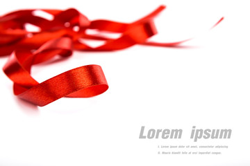 Shiny red ribbon on white background with copy space.