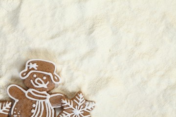 Christmas gingerbread on flour background with copy space