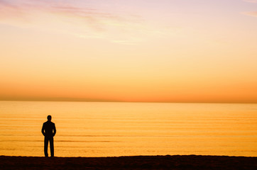 Fototapeta premium Businessman enjoying the sunrise before going to work