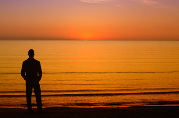 Fototapeta premium Businessman enjoying the sunrise before going to work