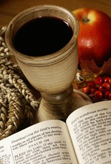 Open Bible and chalice with wine