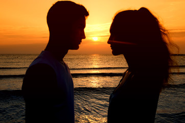 Couple enjoying their time at the sunrise on the beach