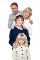 Fototapeta na wymiar Family of four posing in a row