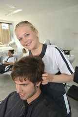 Obraz premium Portrait of hairdressing student girl in hair salon