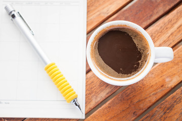 Cup of hot espresso on work wood table