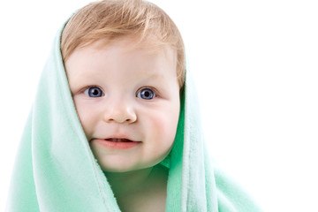 Boy in a green towel on white
