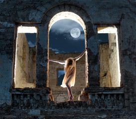 Mysterious female figure in the arc of ruined building