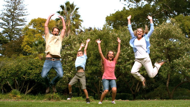 Happy family jumping togethe