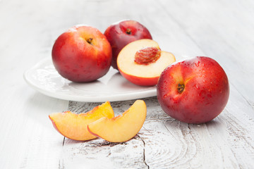 Naklejka na ściany i meble Fresh and tasty peaches on a table