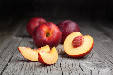 Fresh and tasty peaches on old table