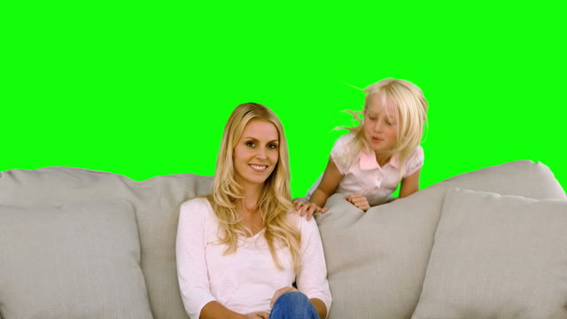 ittle blonde girl surprising her mother on green screen