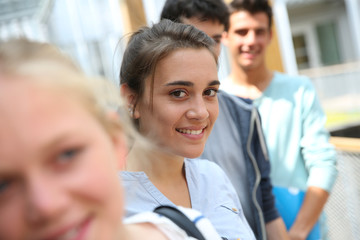 Portrait of smiling school girl amongst group