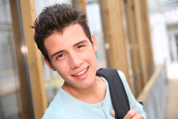 Smiling high-school boy with backpack