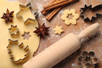 Pastry for Christmas cookies, spices and cookie cutters.
