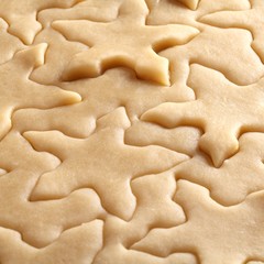Fototapeta na wymiar Pastry for Christmas cookies and snowflake shapes.