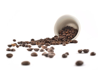 Spilled coffee beans from the cup isolated