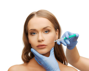 woman face and beautician hands with syringe