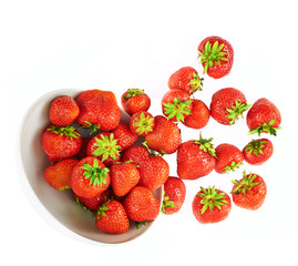 Scattered strawberries in a bowl