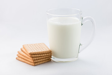Glass of milk with cookies isolated on white background