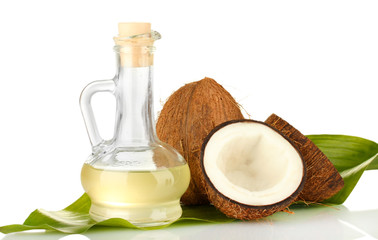 decanter with coconut oil and coconuts isolated on white