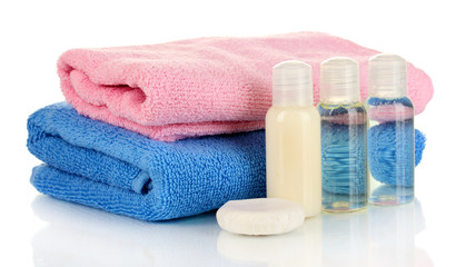 Obraz na płótnie Canvas Hotel cosmetic bottles with towel isolated on white