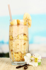 Delicious fruit smoothie on table on blue background