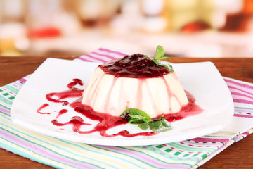 Panna Cotta with raspberry sauce, on bright background