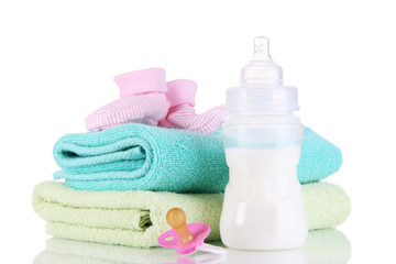 Bottle for milk with towels and nipple isolated on white