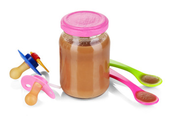 Baby food with baby supplies isolated on white