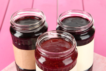 Tasty jam in banks on table close-up
