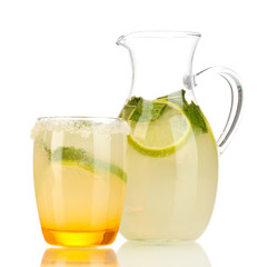 Citrus lemonade in pitcher and glass isolated on white