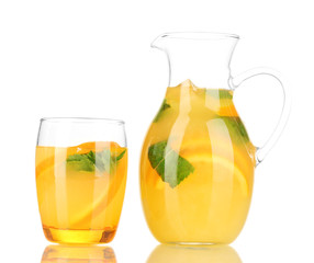 Fototapeta na wymiar Orange lemonade in pitcher and glass isolated on white